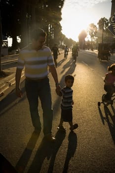 Mid adult man and his son walking on the road, Malecon, Santo Domingo, Dominican Republic
