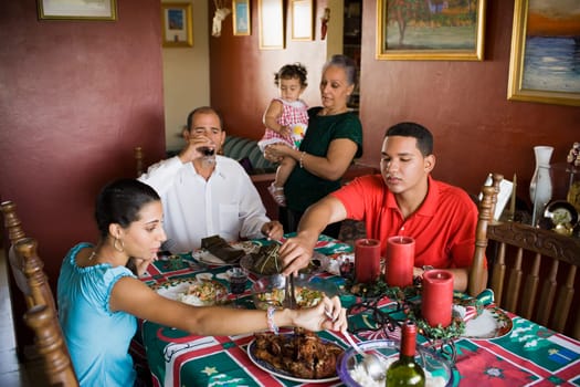 Close-up of a mature couple and their children at the dining table