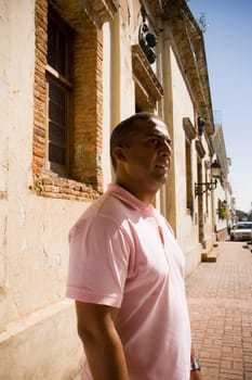 Side profile of a mid adult man standing on the street