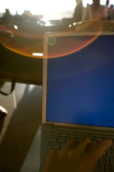Close-up of a person's hand using a laptop