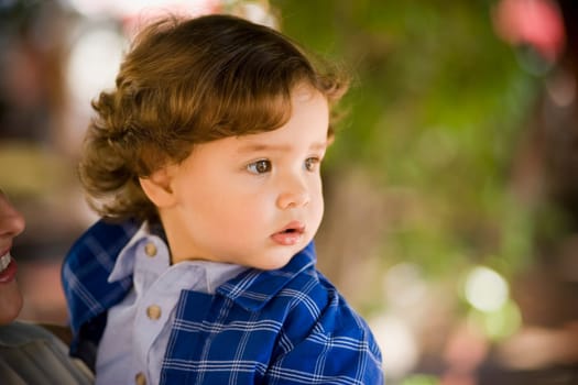 Close-up of a boy carried by his mother