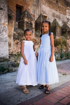 Portrait of two girls smiling and standing together