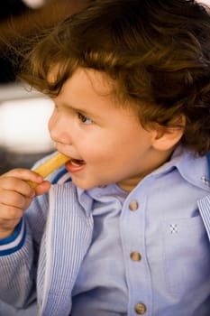 Close-up of a baby boy eating snacks