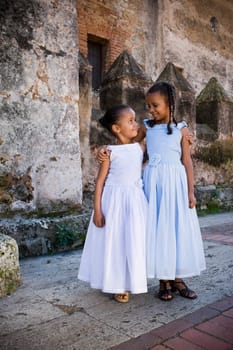Two girls smiling together with their arms around each other