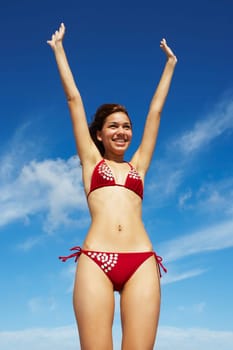 Young woman stretching on beach