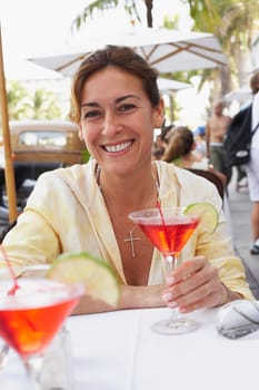 Two women having a cocktail at sidewalk cafe