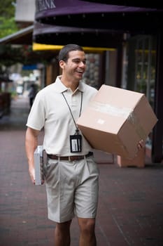 Delivery man carrying large box