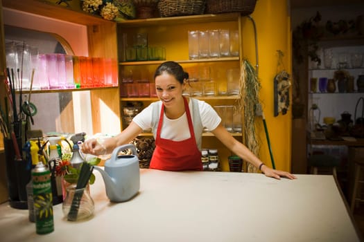 Young woman in flower shop with rose arrangement