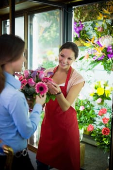 Flower shop owner helping customer