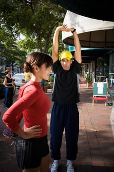 Young woman exercising with physical trainer