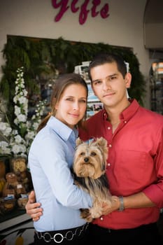 Young couple holding dog
