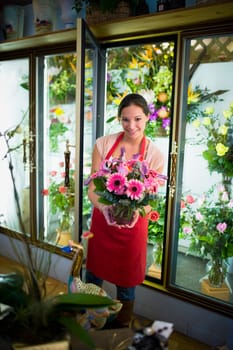 Flower shop owner holding arrangement