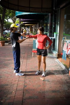Young woman exercising with physical trainer