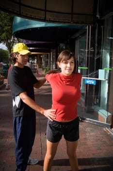 Young woman exercising with physical trainer