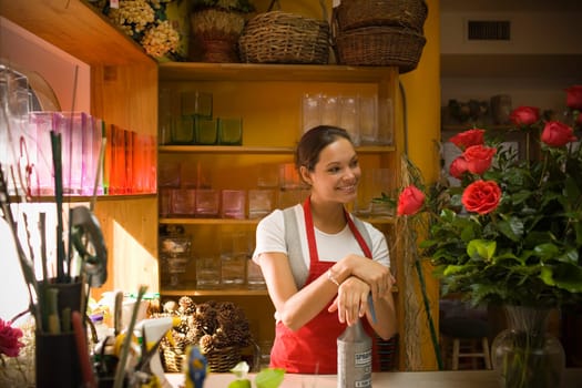 Young woman in flower shop with rose arrangement