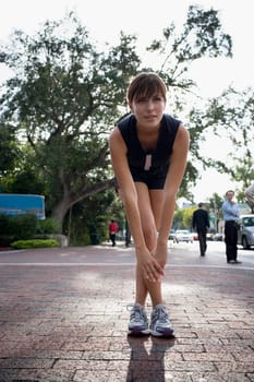 Young woman exercising with physical trainer