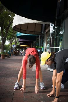 Young woman exercising with physical trainer