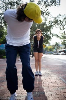 Young woman exercising with physical trainer