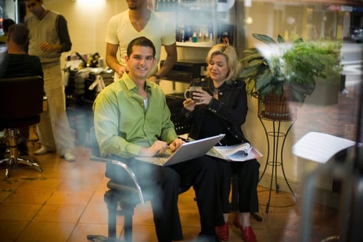 Salon owner discusses business with partner