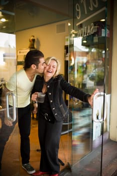 Young man kisses salon owner on cheek