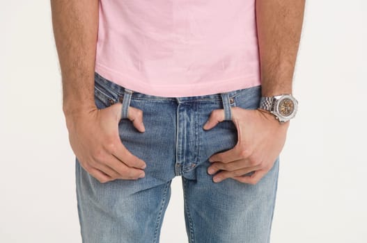 Man with fingers looped in belt loops