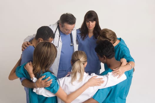 Group portrait of nurses and doctors in huddle