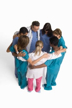 Group portrait of nurses and doctors in huddle