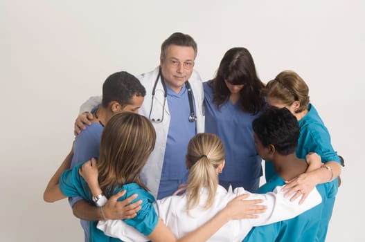 Group portrait of nurses and doctors in huddle