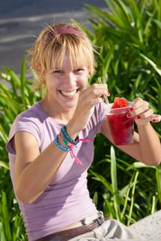 Young woman drinking frozen drink