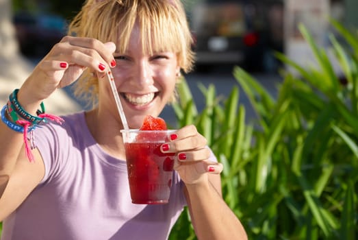 Young woman drinking frozen drink