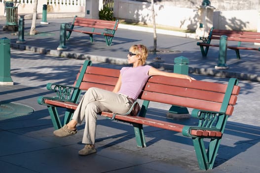 Young woman sitting on park bench