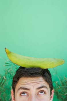 Young man balancing plantain on head