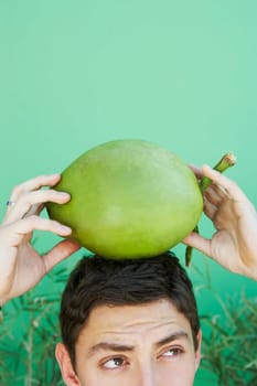 Young man balancing coconut