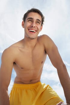 Low angle view of a young man smiling