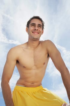 Low angle view of a young man smiling