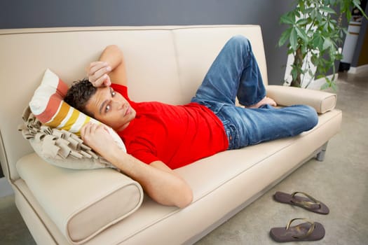 Portrait of a young man lying on a couch