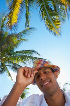 Portrait of a young man adjusting his hat