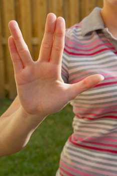 Mid section view of a woman making a hand sign