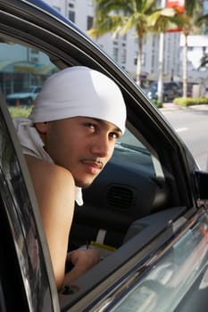 Close-up of a young man sitting in a car