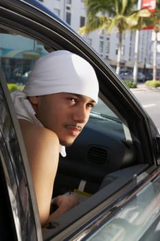 Close-up of a young man sitting in a car