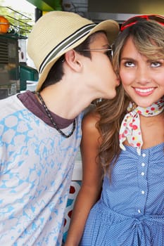 Close-up of a teenage girl being kissed by her boyfriend