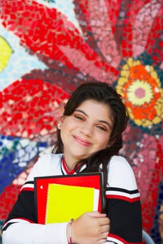 Portrait of a cheerleader holding books and smirking