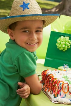 Portrait of a boy wearing a cowboy hat at a birthday party