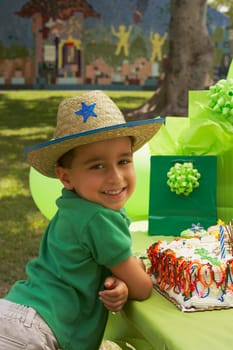 Portrait of a boy wearing a cowboy hat at a birthday party