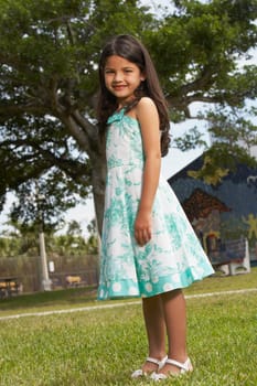 Side profile of a girl standing in a park