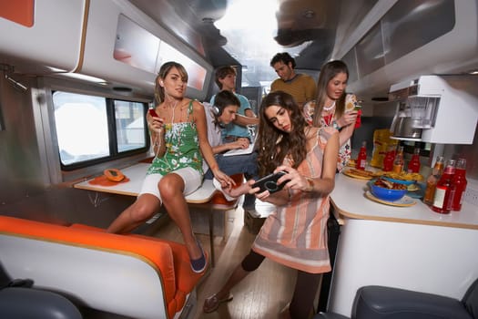 Group of people enjoying in a camper van
