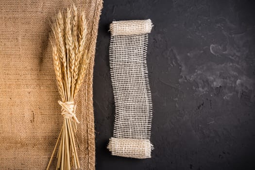 Ears of grain. Golden ears of wheat on burlap textile