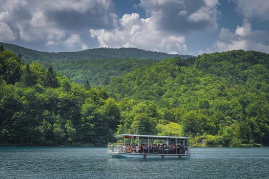 Plitvicka Jezera, Croatia, July 2019 Ferry with tourists on turquoise coloured lake. Plitvice Lakes National Park UNESCO World Heritage