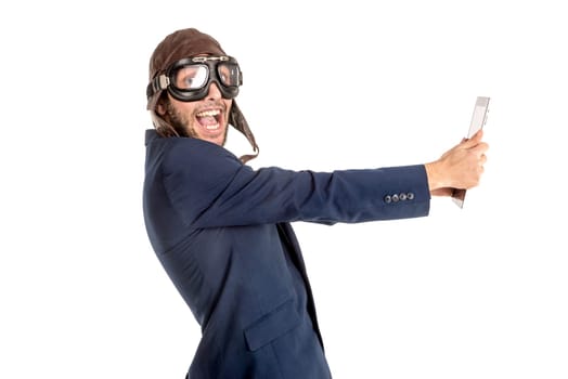 Businessman with pilot goggles and tablet isolated in white
