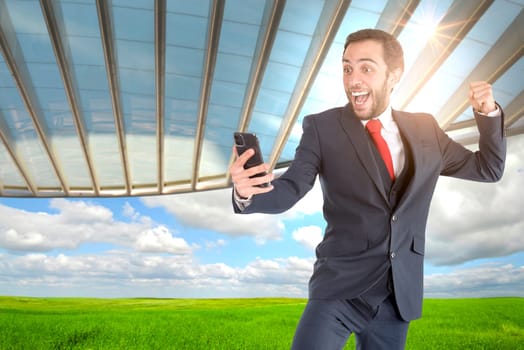 Happy businessman or stock broker with mobile phone outdoors